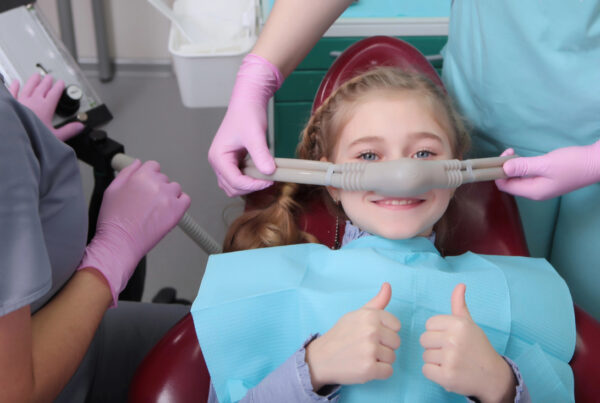 little girl receiving sedation at dentist